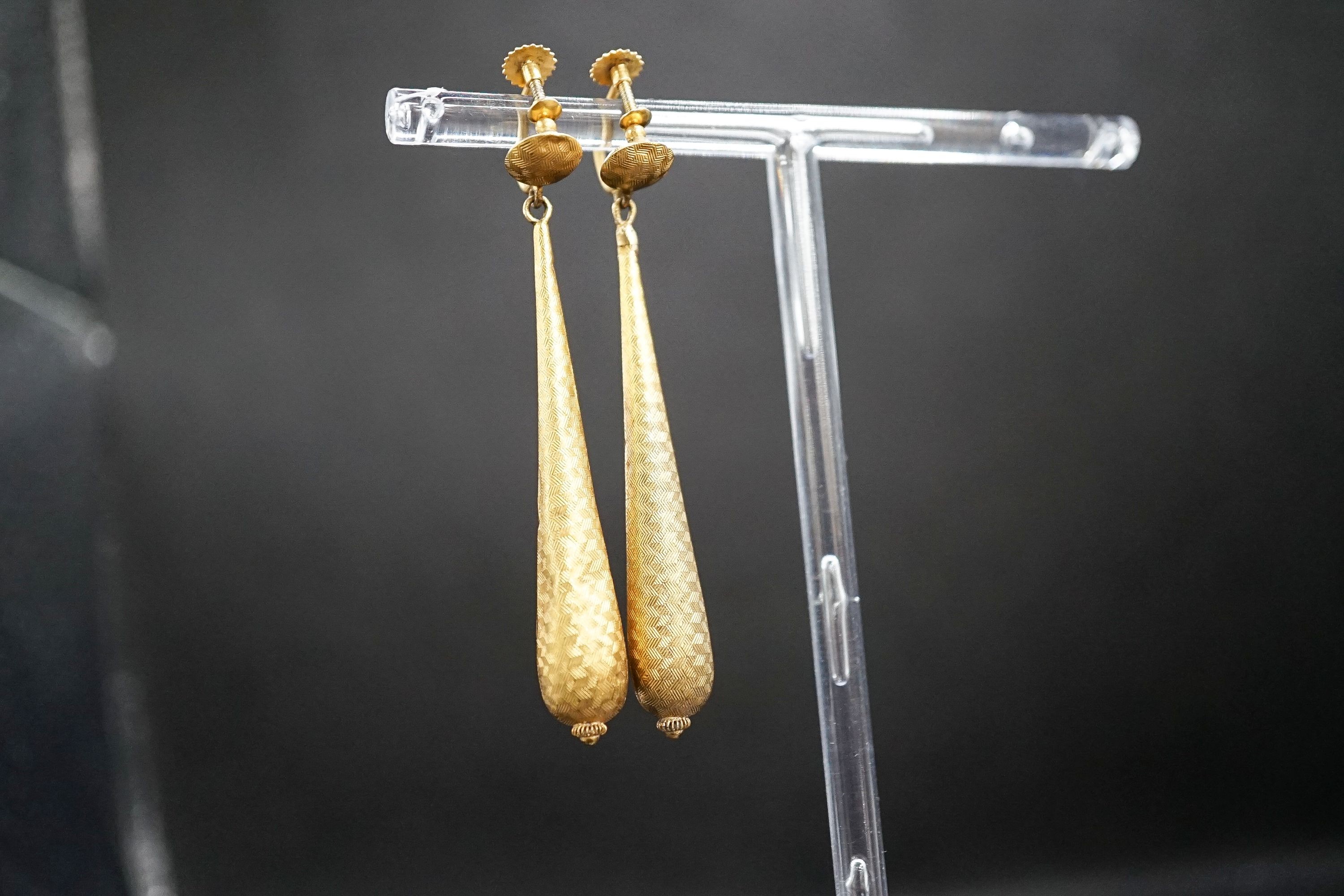 A pair of hollow, yellow metal teardrop shaped earrings, (a.f.), 6cm, 3.3 grams.